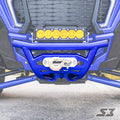 Close-up of an S3 Power Sports 2018+ Polaris Rzr Xp Turbo S Front Winch Bumper, featuring a metallic winch and hook at the center, topped with a bar of six yellow LED lights. Pavement and parts of the grille and suspension are visible.