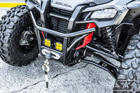 Close-up of a Honda Talon 64 with S3 Power Sports 2019+ HD High Clearance Lower A-Arms, featuring large knobby tires, a black bumper, yellow LED lights, and a mounted winch with synthetic rope on gray pavement.