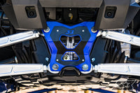 Close-up of the S3 Power Sports 2018+ Polaris RZR XP Turbo S HD Double Shear Radius Rod Plate in metallic blue and black at the center, surrounded by clean silver control arms and bolts, featuring intricate details and a visible logo.