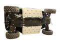 The Polaris General Skid Plate Full Set (Aluminium/Plastic) is shown installed under a rugged off-road vehicle, featuring triangular cutouts, visible bolted joints, and reinforced protection for the chassis with large knobby tires.