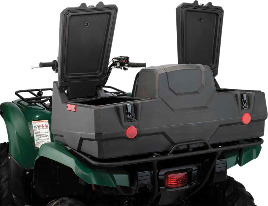 A green ATV with a large, black rear storage box attached. The storage box has two open compartments with raised lids and visible latches. Red reflectors are mounted on the box, and the ATV’s handlebars and part of the rear brake light are visible.