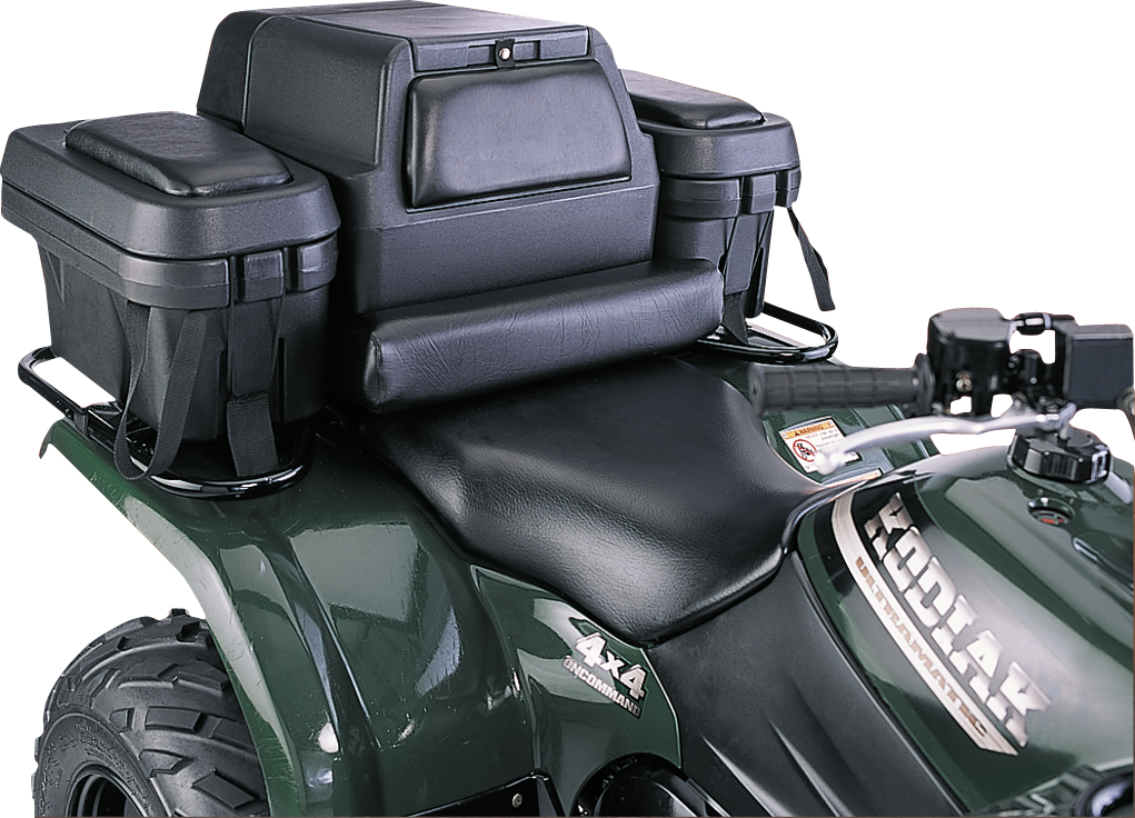 A close-up of a dark green ATV with black padded rear cargo boxes and a cushioned passenger backrest mounted behind the seat. The ATV has Kodiak branding and 4x4 marked on its side. The handlebars and part of the tire are visible.