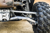 Close-up of S3 Power Sports 2019+ Honda Talon R HD Billet Aluminum Radius Rods, High Clearance Lower, showcasing the sturdy metal rods among suspension components and rugged tires on dusty concrete.