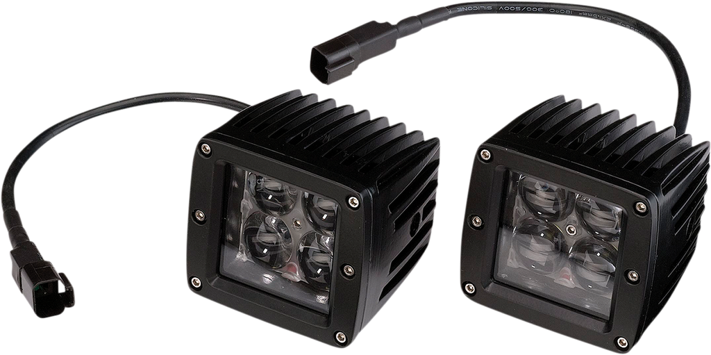 Two black, square LED off-road lights with ribbed heat sinks and clear lenses each covering four LED bulbs. Both lights have attached black power cables ending in connectors, and are positioned side by side on a white background.