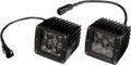 Two black, square LED off-road lights with ribbed heat sinks and clear lenses each covering four LED bulbs. Both lights have attached black power cables ending in connectors, and are positioned side by side on a white background.