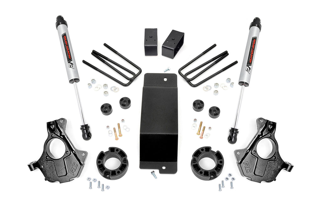 The 3.5 Inch Lift Kit | Cast Steel LCA | V2 for Chevy/GMC 1500 (07-13) is shown on a white background, featuring two shock absorbers, black knuckles, U-bolts, spacers, brackets, a skid plate, and hardware arranged symmetrically.