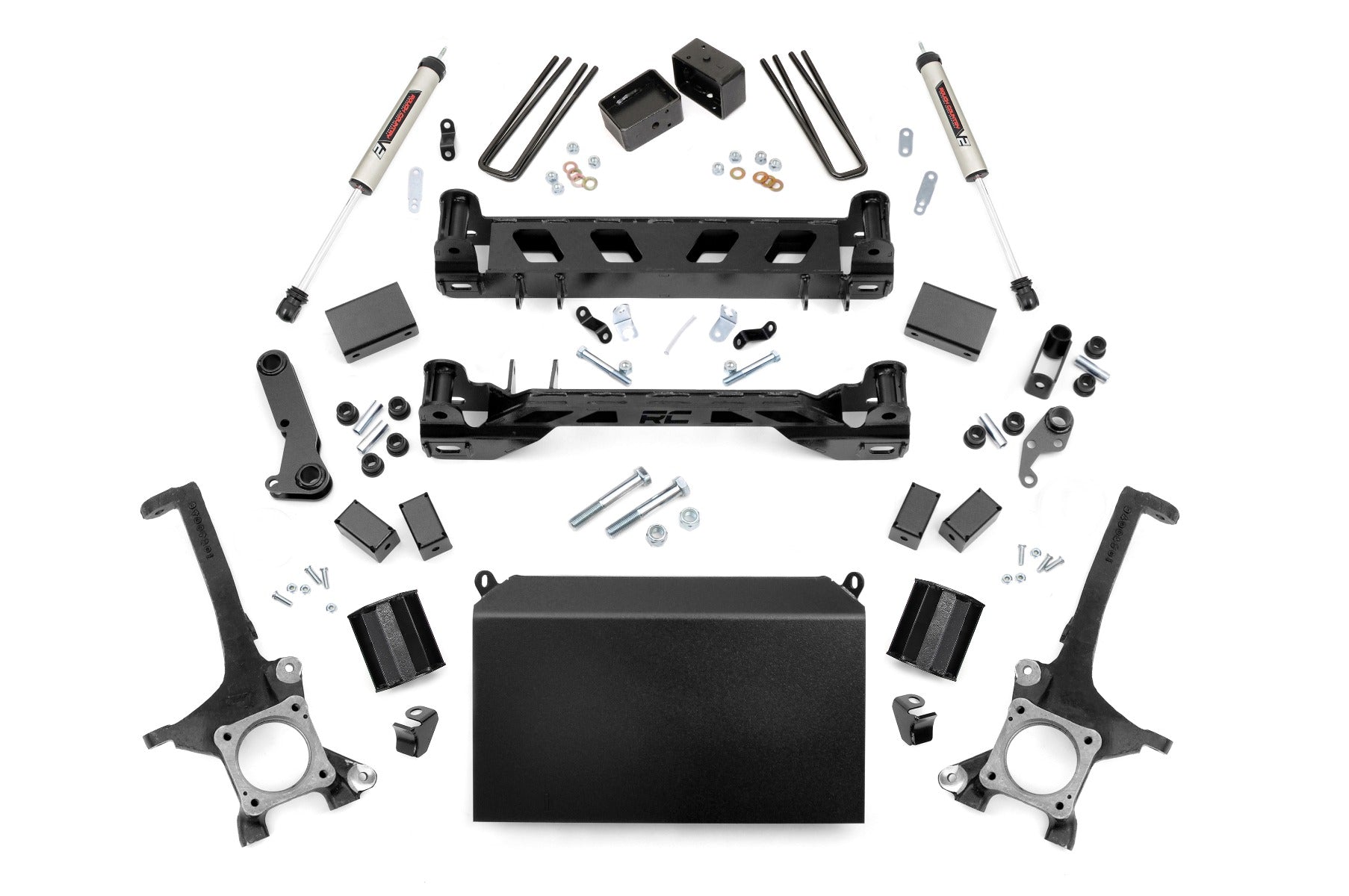 The 4 Inch Lift Kit | V2 for Toyota Tundra 2WD/4WD (2016-2021) is displayed on a white background with black metal brackets, control arms, shock absorbers, spacers, bolts, nuts, U-bolts, and a large case-like component arranged neatly.