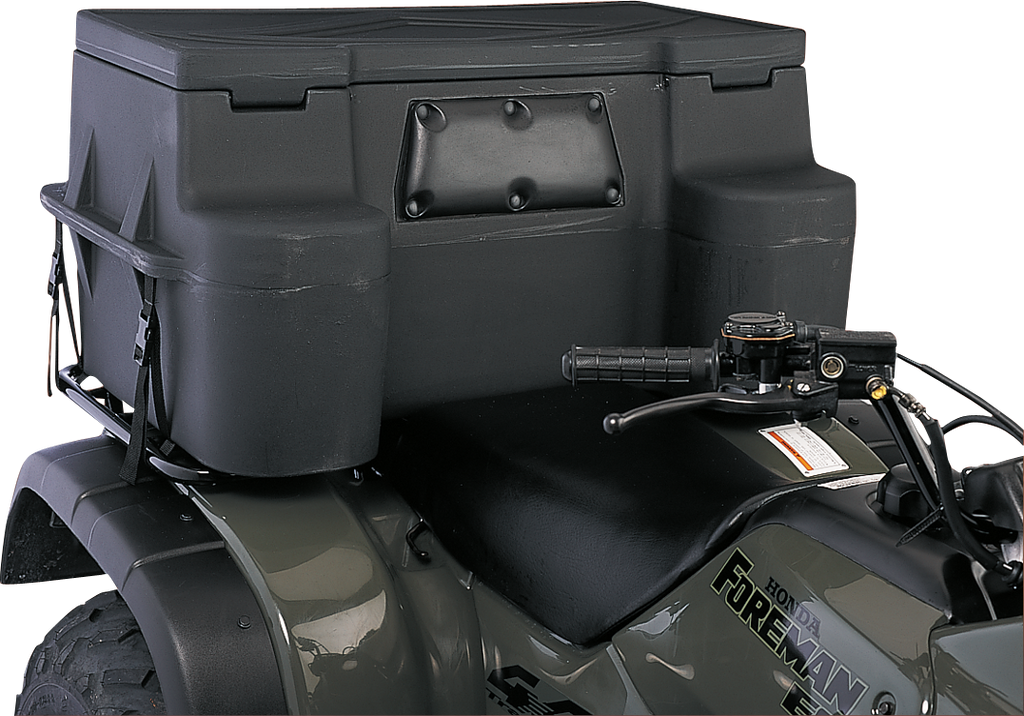 Close-up of a black Honda Foreman ATV showing the seat, handlebars, and a large, rugged black storage box mounted on the rear rack. The storage box has a reinforced rectangular panel and textured surface. No people are visible.