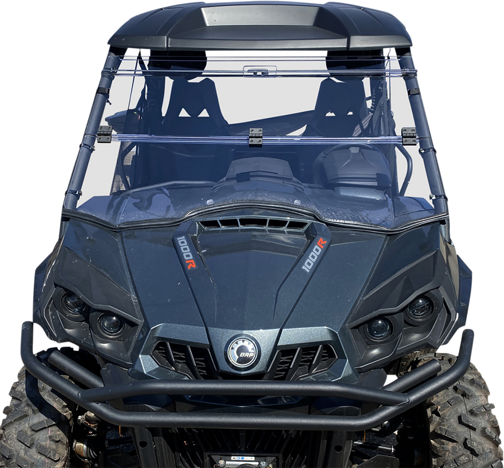 A front view of a dark gray off-road utility vehicle with large rugged tires, a clear full windshield, dual front seats, and visible “1000R” branding on both sides of the hood. The vehicle has a robust front bumper and angular headlights.
