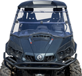 A front view of a dark gray off-road utility vehicle with large rugged tires, a clear full windshield, dual front seats, and visible “1000R” branding on both sides of the hood. The vehicle has a robust front bumper and angular headlights.