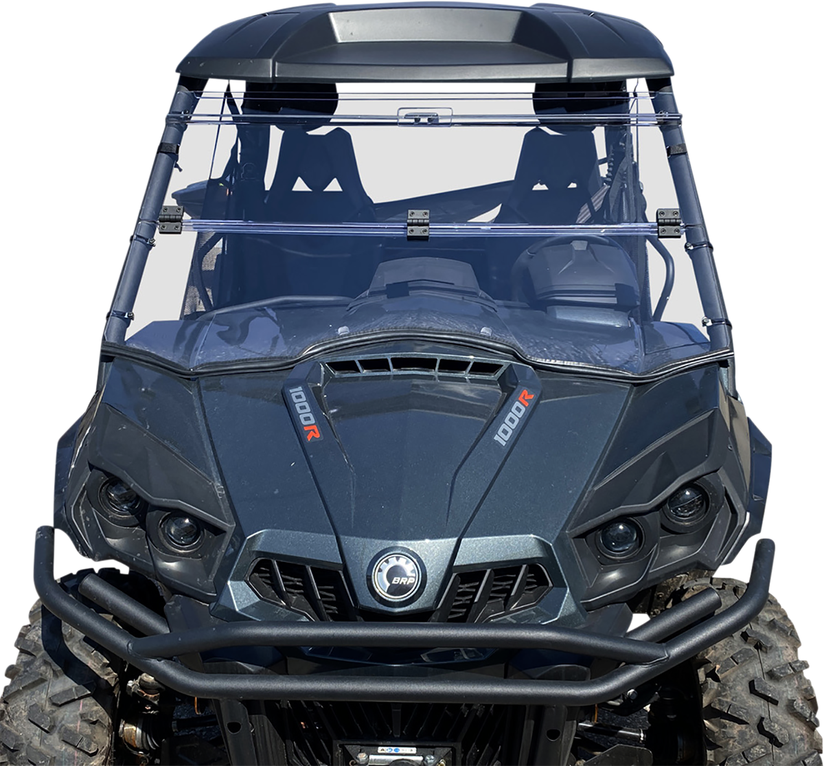 A front view of a dark gray off-road utility vehicle with large rugged tires, a clear full windshield, dual front seats, and visible “1000R” branding on both sides of the hood. The vehicle has a robust front bumper and angular headlights.