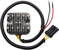 A silver metal voltage regulator with vertical fins is attached to a black, coiled wire harness. The harness has yellow, red, and black wires, ending in a black plastic connector and two ring terminals. The background is plain white.