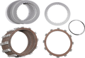 A set of motorcycle clutch plates and discs are arranged on a white background. The top left shows several smooth metal plates stacked together, top middle shows toothed metal plates, top right shows a thin black O-ring, and the bottom displays two stacks