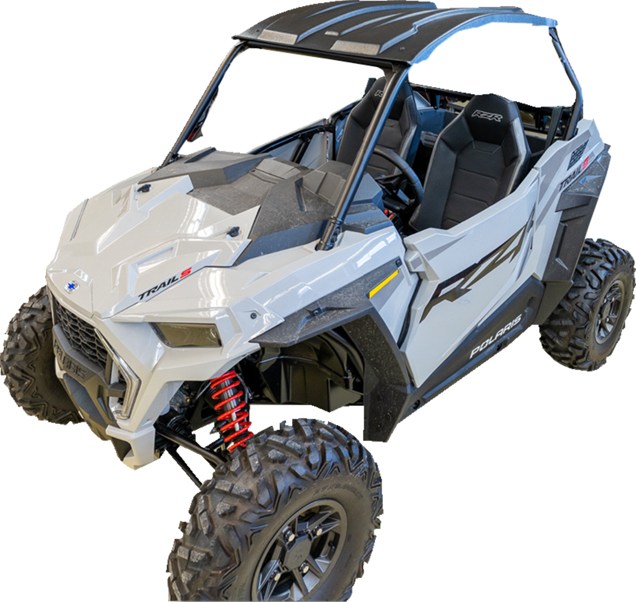 A white, open-cabin off-road Polaris RZR vehicle with large rugged tires, visible red coil suspension springs, a black roof, and two seats. The body has angular lines and Polaris and RZR logos on the side.
