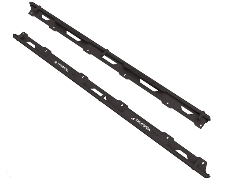 Two long, black metal rails, labeled 2018+ Tracker 800SX CREW Nerf Rail Set (DS/PS), with angular cutouts and mounting holes, lie parallel on a white background. The rails appear to be components for vehicle assembly.
