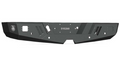 A textured black metal Road Armor Spartan rear bumper for 2015-2019 Chevy/GMC 2500 trucks, featuring geometric beveled edges, cutouts, mounting holes, a white 3152XR code at the center, and a stylized logo on the left.
