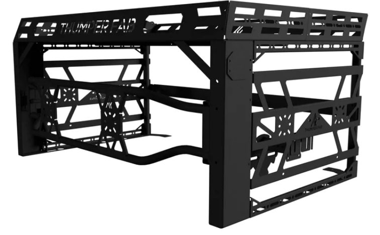 The 2018+ Polaris Ranger Ultimate Bed Rack (Black) is a heavy-duty metal rack with angular supports, cut-out patterns, side rails, and THUNDER RACK text on the front panel, designed for carrying cargo and securing gear.