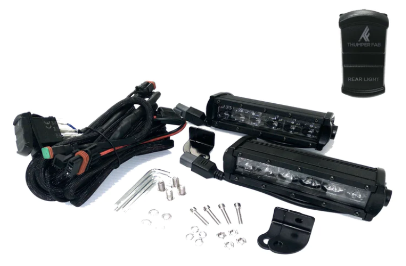 Rear Light Kit - 2016+ Polaris General displayed on a white background, featuring two black LED light bars, wiring harnesses with connectors, mounting brackets, assorted screws and washers, plus a small black part labeled Thumper Fab Rear Light.