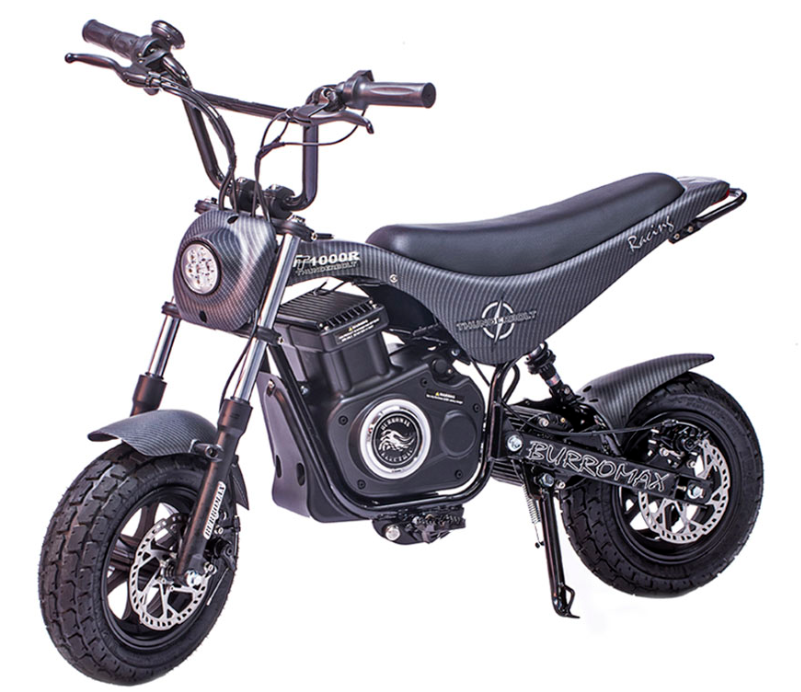 A black Electric Mini Bike, TT1000R Lithium Ion Powered, features chunky tires, a cushioned seat, round LED headlight, carbon-fiber patterned frame with “Burromax” branding on the side; shown on a white background with kickstand down.
