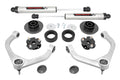 The 3 Inch Lift Kit | V2 for Ram 1500 4WD (2012-2018 & Classic) is displayed on a white background with two silver shock absorbers, two control arms, coil and strut spacers, mounting hardware, and black plastic or rubber components.