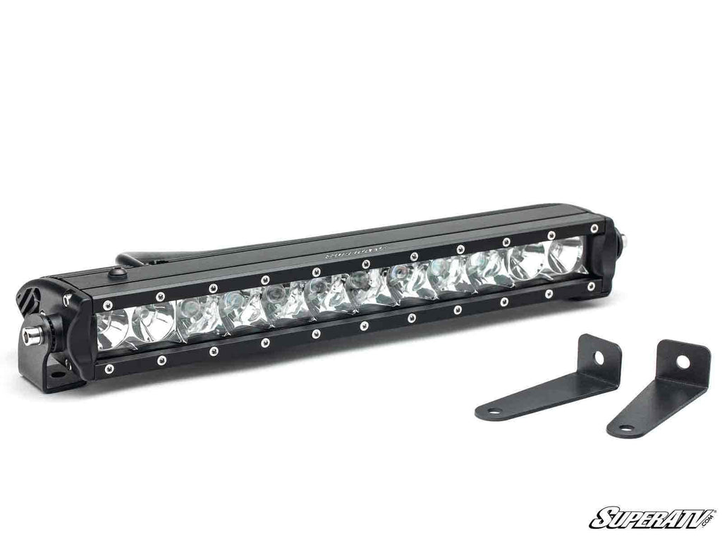 A black, rectangular 12 LED Single-Row Light Bar with 12 bulbs and a metal frame is pictured next to two black L-shaped mounting brackets. The SuperATV logo appears in the lower right on a white background.