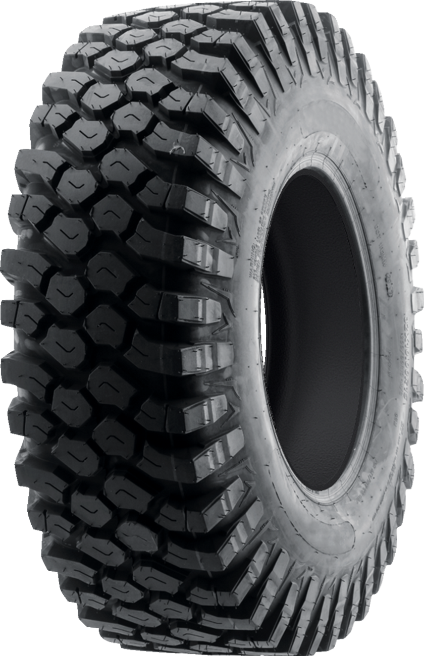 A large black off-road tire with deep, aggressive tread patterns, wide sidewalls, and a rugged design, positioned vertically against a plain white background. The tire appears new and unused.
