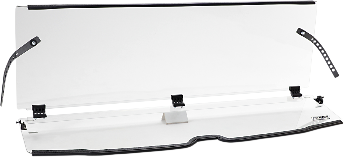 A clear acrylic sneeze guard with black adjustable mounting straps and clamps, slightly angled and supported by a central stand. The guard has a narrow base with a logo on the right side and is designed for countertop protection, likely for use in custome