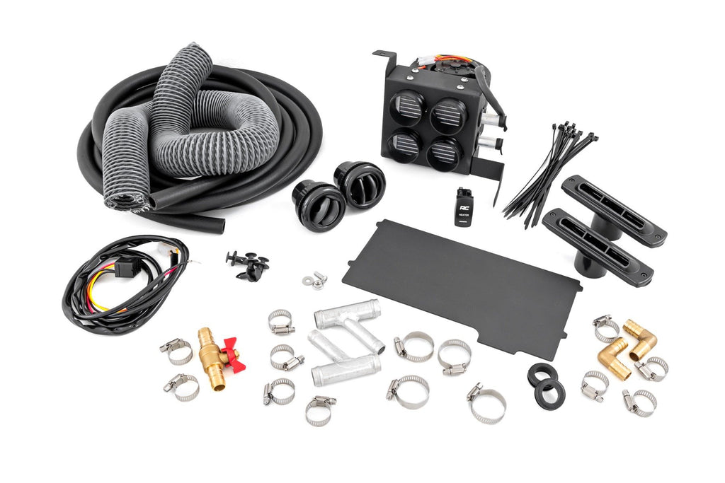 The Cab Heater for Can-Am Defender HD 8/HD 9/HD 10 is shown on a white background with hoses, vents, hose clamps, electrical wiring, a black control unit with four circular outlets, connectors, zip ties, and assorted metal and plastic fittings.