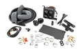 The Cab Heater for Can-Am Defender HD 8/HD 9/HD 10 is shown on a white background with hoses, vents, hose clamps, electrical wiring, a black control unit with four circular outlets, connectors, zip ties, and assorted metal and plastic fittings.