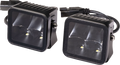 Two black, square-shaped LED work lights with clear lenses, mounted in metal housings. Each light contains two LED bulbs and reflective interiors. Power cables with connectors extend from the back of the lights, designed for off-road or automotive use.
