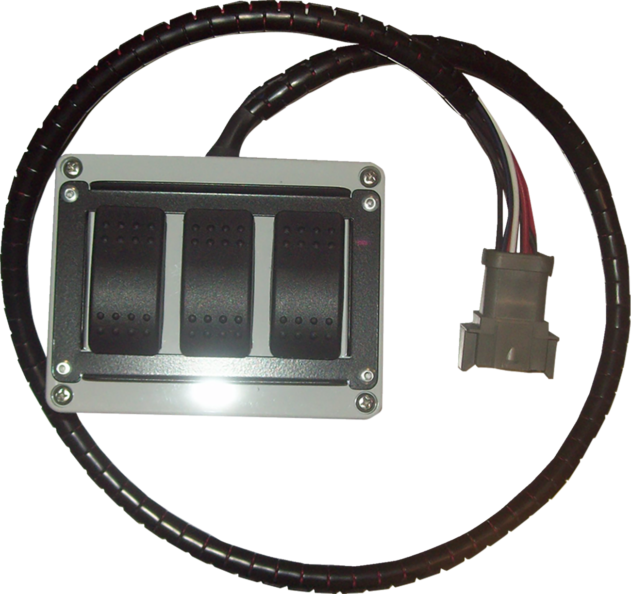 A rectangular electrical switch box with three black rocker switches is attached to a thick black cable, which is coiled around the box. The cable ends with a gray connector that has exposed colored wires.