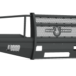 The 1999-2007 Ford F250 Vaquero Front Non-Winch Bumper Full Guard in textured black features a heavy-duty, matte finish with mesh panels, angular lines, a solid lower section, perforated grille, and central logo for strong front-end protection.