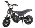 The Burromax Electric Mini Bike TT350R, in matte black carbon fiber, features thick knobby tires, raised handlebars, a cushioned seat, circular headlight, visible full suspension, pedals, and a sturdy frame. The Burromax brand appears on the side.