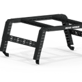 The 2005+ Toyota Tacoma Treck 5Ft. Bed Mid-Size Truck Adjustable Bed Rack System in textured black features angular metal legs, crossbars, perforated side holes for attachments, a ROAD ARMOR logo, and includes a bracket kit. Plain white background.