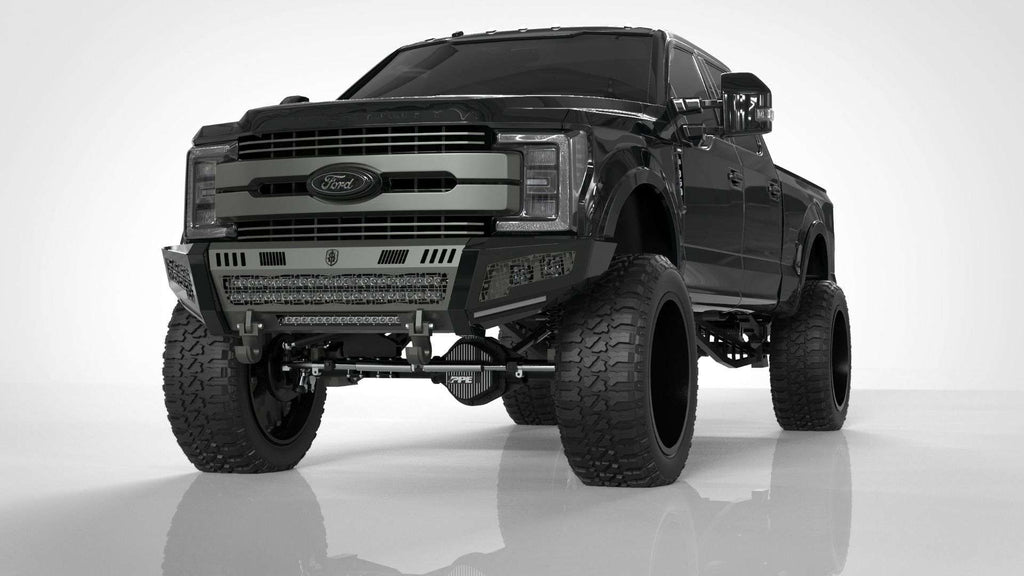 A 2017-2021 Ford F-250 with an Identity Front Bumper Full Kit (center section shackle, standard end pods, X2 cube light pods, accent lights, raw steel) is displayed in a studio, highlighting rugged modifications and an aggressive stance.