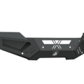The 2015-2019 GMC 2500 Spartan Front Bumper by Road Armor features a textured black, angular design with geometric lines, cutouts, reinforced corners, a stylized X and circular logo—offering rugged protection with sharp edges and mounting points.