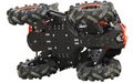 A close-up shows the black plastic skid plate full set for the CanAm Renegade X MR (2019+), highlighting its geometric frame, large rugged tires, orange suspension springs, metal screws, and robust design for off-road protection.