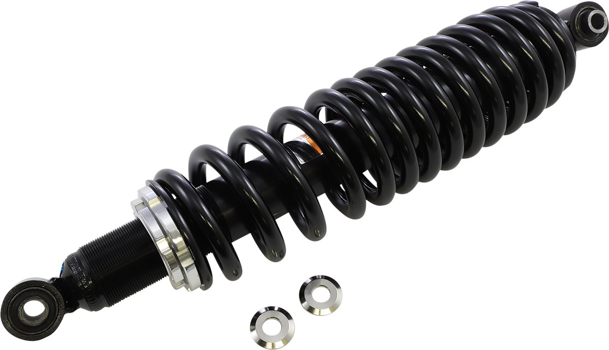 A black coilover shock absorber with a metal coil spring wrapped around a cylindrical body, featuring mounting loops at both ends. Two flat, circular metal washers are placed next to it on a plain white background.