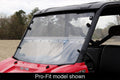 A Polaris Full Size Round Tube Ranger with a Windshield Versa-Fold (UV Resistant Poly) is parked outdoors. The clear windshield, fastened by black brackets, is shown on a red off-road vehicle with trees and grass in the background. Pro-Fit model shown.