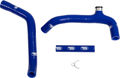 Two blue silicone hoses with “Samco Sport” logos, a short blue connector tube, and a small metal clamp, all laid out on a white background. One hose has a metal fitting on the end. The hoses are for automotive or motorsport use.