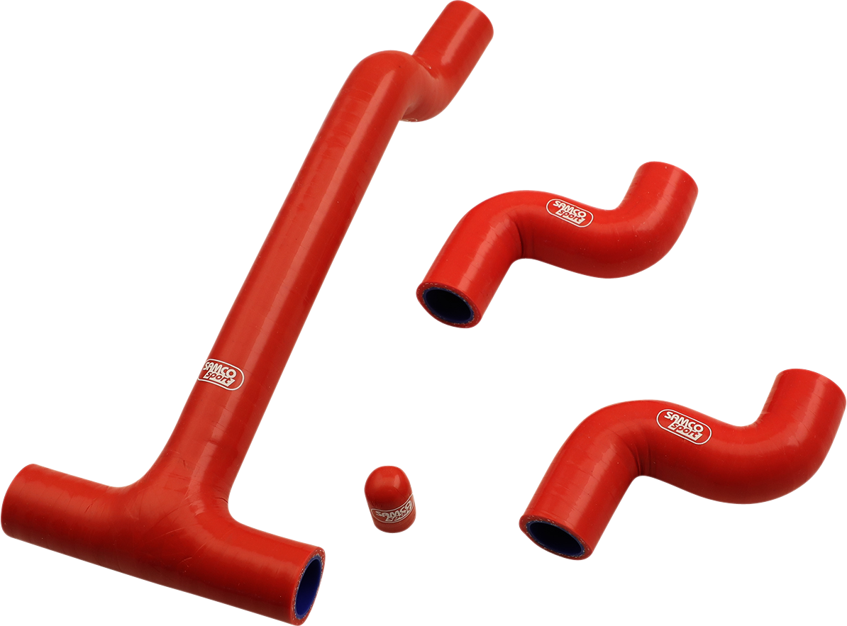 Four red silicone hoses of various shapes and sizes are arranged on a white background. Three are bent at angles, and one is a short, straight cylinder. All hoses have white SAMCO SPORT logos printed on them.