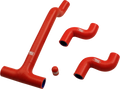 Four red silicone hoses of different shapes and sizes are arranged on a white background. Three hoses have bends and one is a small cylindrical cap. All pieces have white logos and blue interiors visible at the openings.