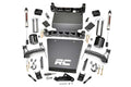 A 5 Inch Lift Kit for Chevy/GMC 1500 (14-18) with black brackets, V2 shocks, RC skid plates, spacers, U-bolts, bolts, nuts, washers, and hardware is laid out on a white surface.