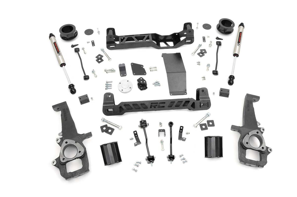 The 4 Inch Lift Kit | V2 for Ram 1500 4WD (2012-2018 & Classic) is displayed on a white background, featuring crossmembers, shock absorbers, spindles, spacers, brackets, bolts, washers, and hardware neatly organized in rows.