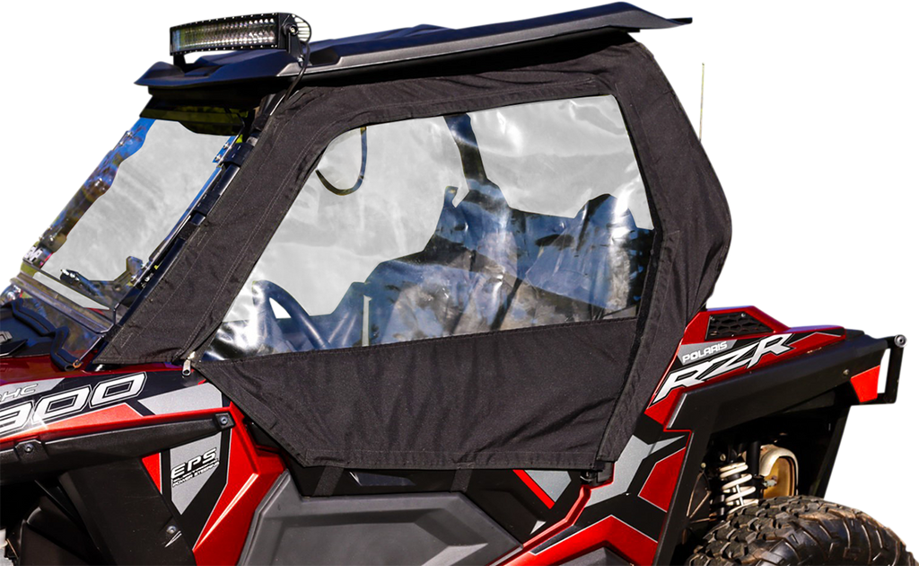 A close-up of a red Polaris RZR off-road vehicle with a black soft door and clear plastic window panel installed. The roof is black with a mounted LED light bar, and the image emphasizes the vehicle’s right side, showing rugged design details.
