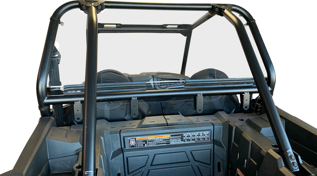 A close-up view of the rear roll cage and cargo area of an off-road utility vehicle, featuring sturdy black metal bars, a flat rear frame, secured cargo bed, and safety and instruction labels on the interior panel, all against a plain white background.