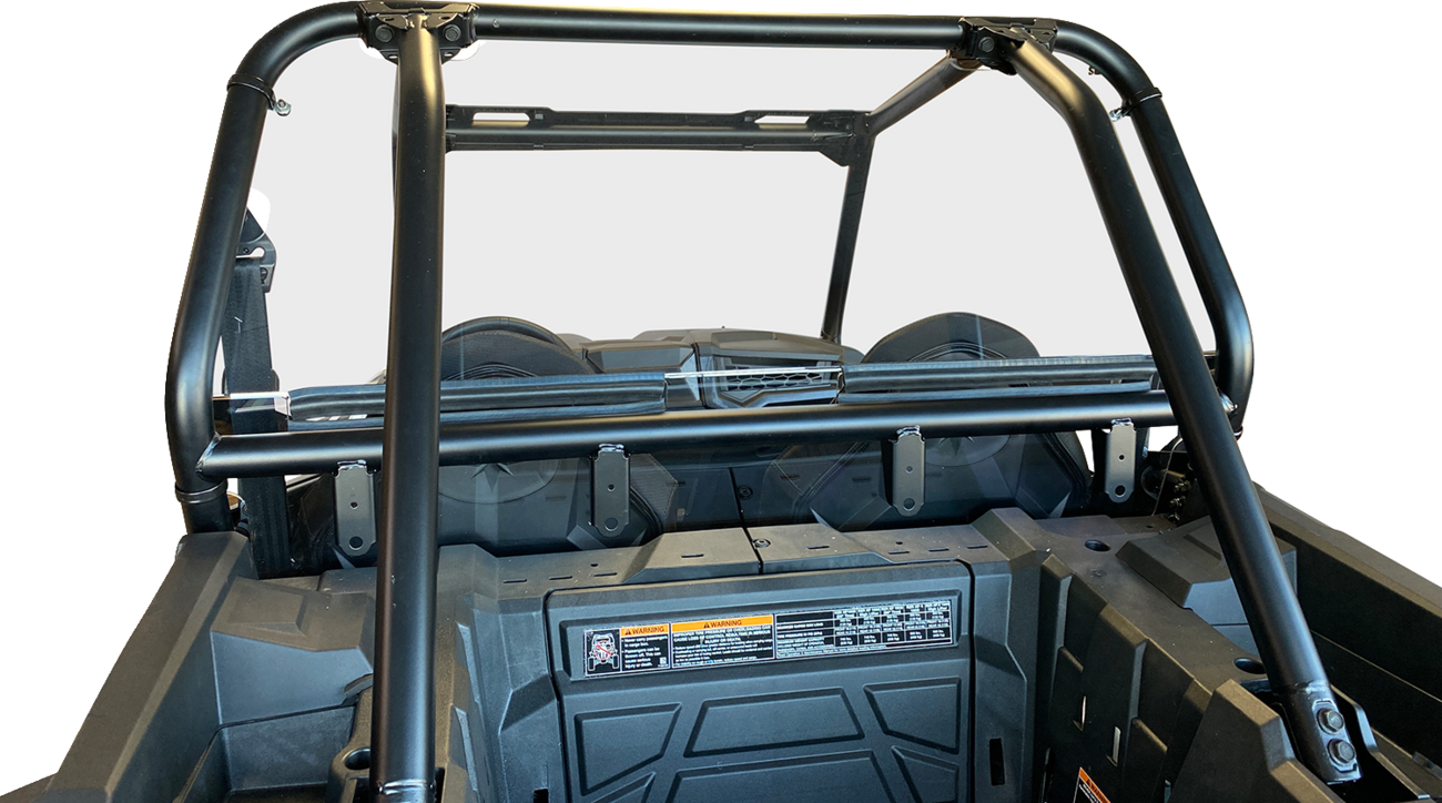 A close-up view of the rear roll cage and cargo area of an off-road utility vehicle, featuring sturdy black metal bars, a flat rear frame, secured cargo bed, and safety and instruction labels on the interior panel, all against a plain white background.