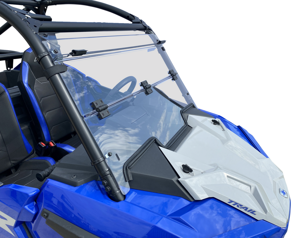 A blue off-road vehicle with a clear, foldable windshield attached by black hinges. The frame is black with padded bars, and the interior features black seats with blue accents. The word TRAIL is visible on the white section of the front hood.