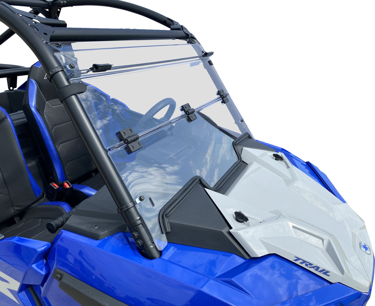 A blue off-road vehicle with a clear, foldable windshield attached by black hinges. The frame is black with padded bars, and the interior features black seats with blue accents. The word TRAIL is visible on the white section of the front hood.