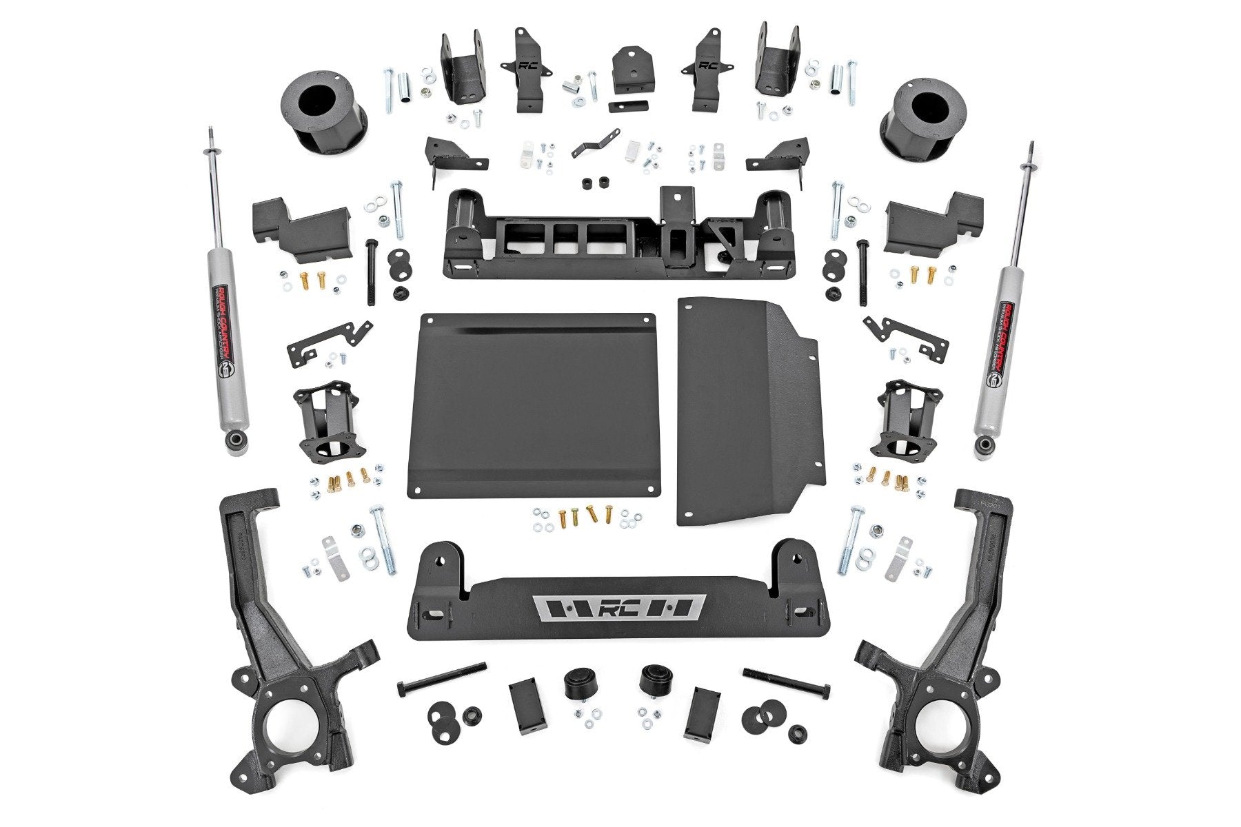 The 6 Inch Lift Kit | N3 for Toyota Tundra 2WD/4WD (2022-2025) features black metal and plastic suspension components, brackets, plates, spacers, bolts, and two gray shock absorbers arranged symmetrically on a white background.